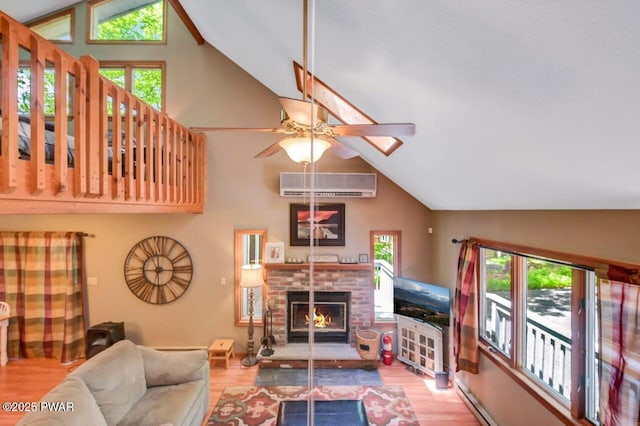 108 Minnow Ct, Lackawaxen, PA 18435 - living area featuring an AC wall unit, a ceiling fan, plenty of natural light, wood finished floors, and high vaulted ceiling