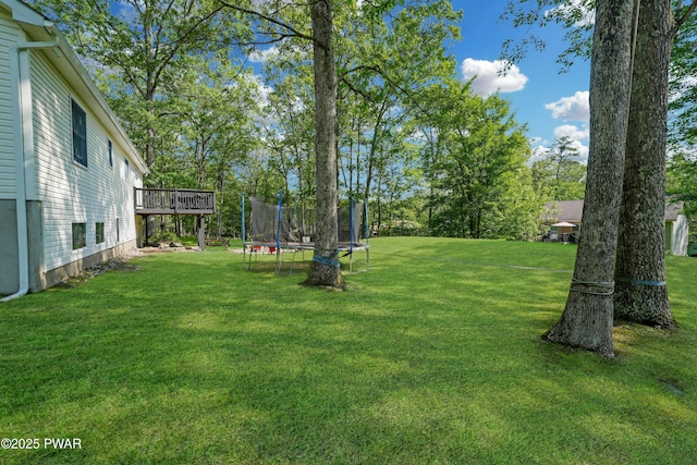 135 Kiel Rd, Milford, PA 18337 - view of grassy yard featuring a trampoline and a deck