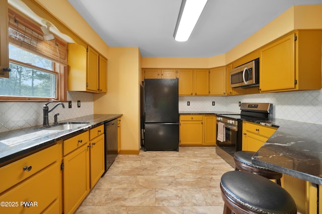 135 Kiel Rd, Milford, PA 18337 - kitchen with black appliances, backsplash, dark stone countertops, and a kitchen bar