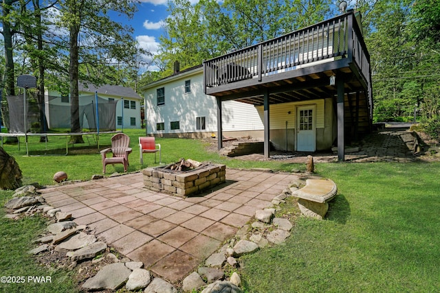 135 Kiel Rd, Milford, PA 18337 - rear view of house featuring a trampoline, a deck, a fire pit, and a patio