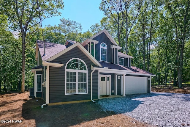 view of front of home with cooling unit and a garage