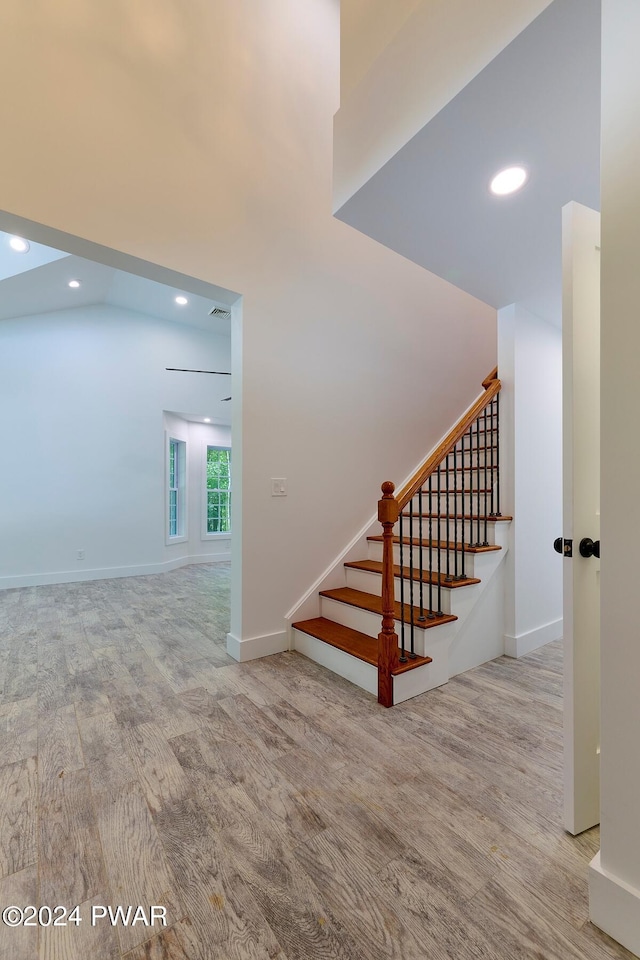 stairs featuring hardwood / wood-style flooring