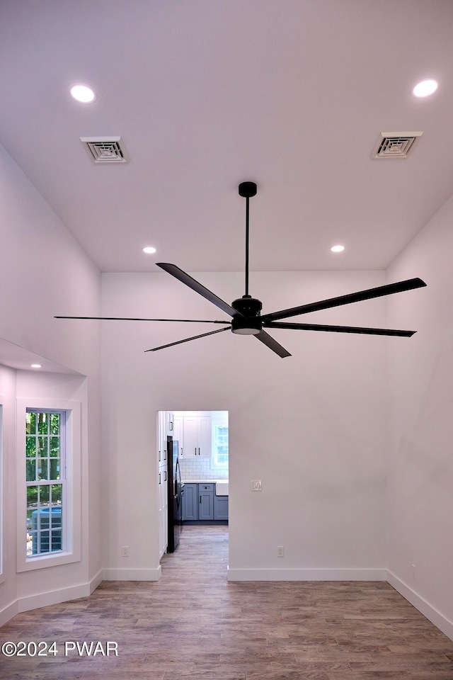 unfurnished living room featuring ceiling fan and light hardwood / wood-style floors