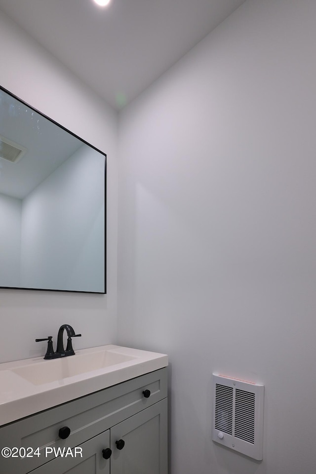 bathroom featuring vanity and heating unit