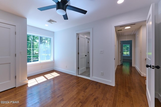 unfurnished bedroom with ceiling fan and dark hardwood / wood-style flooring