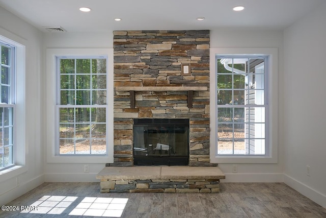 interior details with hardwood / wood-style flooring and a fireplace