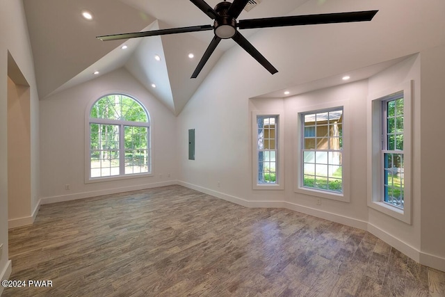 unfurnished room with ceiling fan, electric panel, and vaulted ceiling