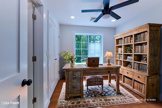 home office featuring dark hardwood / wood-style flooring and ceiling fan