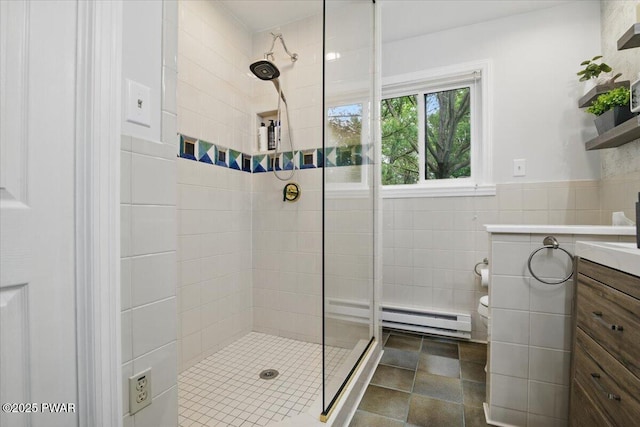 141 Arrowhead Cir, Newfoundland, PA 18445 - full bathroom featuring a baseboard radiator, tiled shower, vanity, tile walls, and toilet