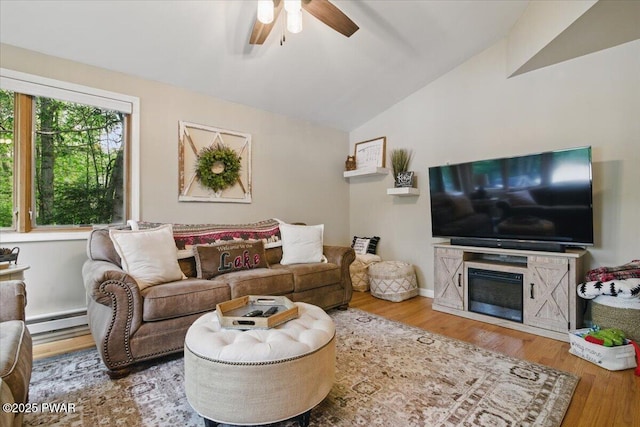 141 Arrowhead Cir, Newfoundland, PA 18445 - living area featuring a baseboard heating unit, lofted ceiling, a ceiling fan, and wood finished floors