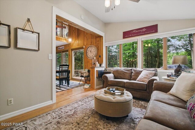 141 Arrowhead Cir, Newfoundland, PA 18445 - living room with lofted ceiling, a ceiling fan, wood finished floors, baseboards, and wood walls