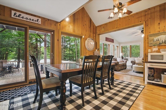 141 Arrowhead Cir, Newfoundland, PA 18445 - dining room featuring wooden walls, lofted ceiling, a ceiling fan, plenty of natural light, and wood finished floors