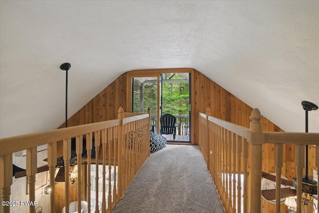 141 Arrowhead Cir, Newfoundland, PA 18445 - hall with wood walls, vaulted ceiling, a textured ceiling, and carpet flooring