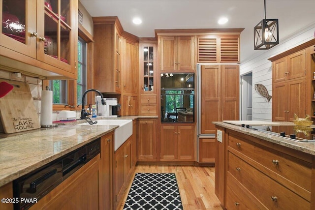 141 Arrowhead Cir, Newfoundland, PA 18445 - kitchen with a sink, brown cabinetry, light wood finished floors, light stone counters, and recessed lighting