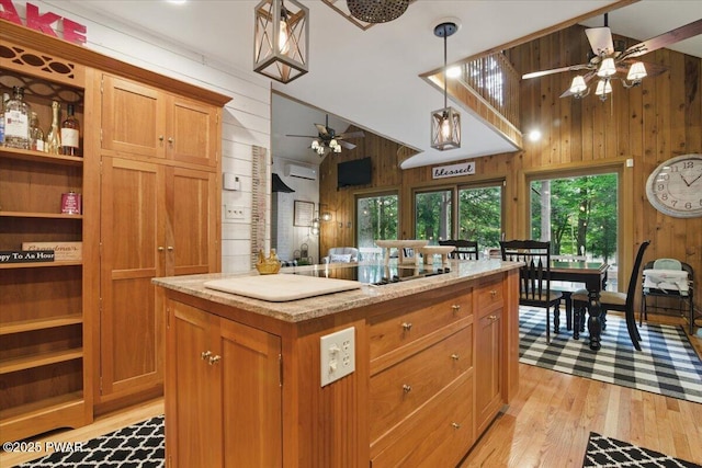 141 Arrowhead Cir, Newfoundland, PA 18445 - kitchen with ceiling fan, wood walls, vaulted ceiling, light wood finished floors, and brown cabinetry