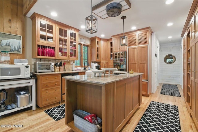 141 Arrowhead Cir, Newfoundland, PA 18445 - kitchen with white microwave, dishwashing machine, light wood-style flooring, a kitchen island, and hanging light fixtures