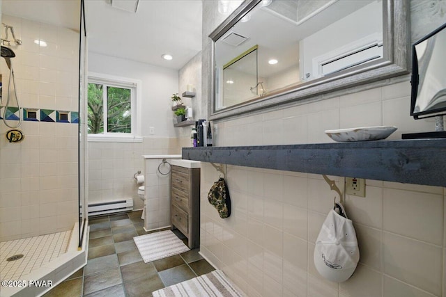 141 Arrowhead Cir, Newfoundland, PA 18445 - bathroom with tile walls, baseboard heating, a tile shower, toilet, and vanity