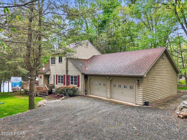 141 Arrowhead Cir, Newfoundland, PA 18445 - view of front of house with a shingled roof, a deck, a garage, and gravel driveway