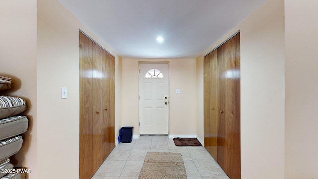 entryway featuring light tile patterned floors and baseboards