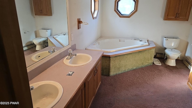 bathroom with toilet, vanity, a baseboard radiator, and a bath