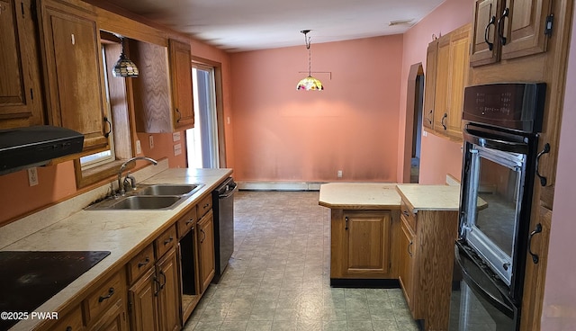 kitchen with black appliances, baseboard heating, sink, and pendant lighting