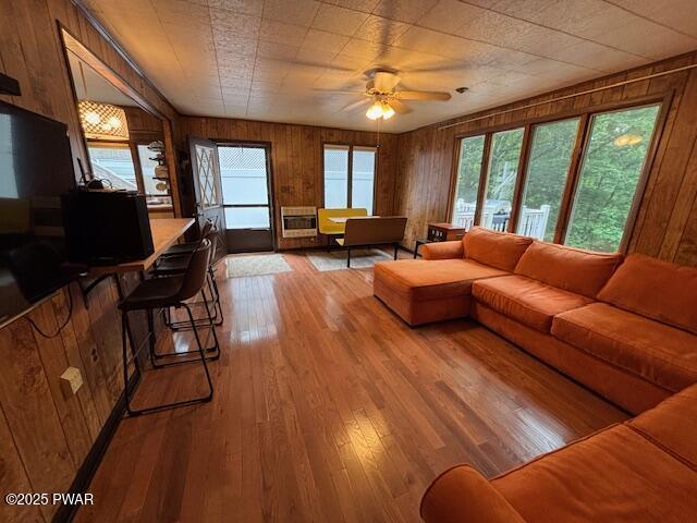 30 Bear Hill Rd, Lake Ariel, PA 18436 - living room featuring wooden walls, hardwood / wood-style flooring, a ceiling fan, and heating unit