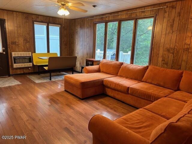 30 Bear Hill Rd, Lake Ariel, PA 18436 - living area featuring heating unit, wooden walls, ceiling fan, and wood finished floors