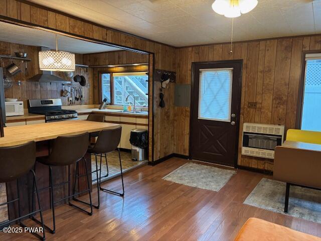 30 Bear Hill Rd, Lake Ariel, PA 18436 - entryway featuring heating unit, wooden walls, dark wood finished floors, and healthy amount of natural light