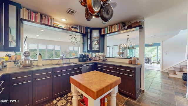 149 Bennett Ave Unit J, Milford, PA 18337 - kitchen with dishwasher, stone tile flooring, glass insert cabinets, butcher block countertops, and a chandelier