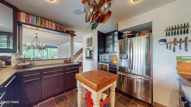 149 Bennett Ave Unit J, Milford, PA 18337 - kitchen featuring stainless steel appliances, glass insert cabinets, a chandelier, wine cooler, and wood counters