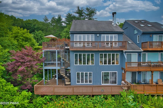 149 Bennett Ave Unit J, Milford, PA 18337 - back of property with stairway, a shingled roof, and a wooden deck