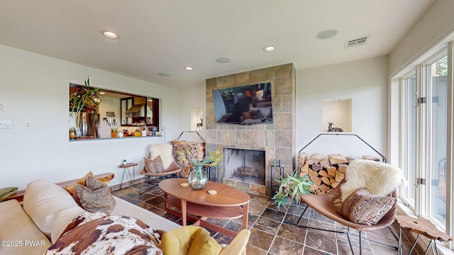 149 Bennett Ave Unit J, Milford, PA 18337 - living room featuring stone finish floors, recessed lighting, and a tiled fireplace