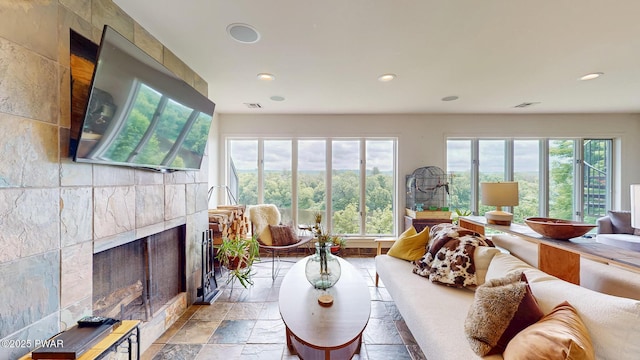 149 Bennett Ave Unit J, Milford, PA 18337 - living area featuring healthy amount of natural light, recessed lighting, a tile fireplace, and stone tile floors