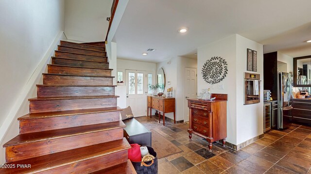 149 Bennett Ave Unit J, Milford, PA 18337 - stairway featuring beverage cooler, stone tile floors, and recessed lighting