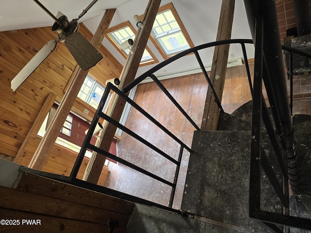 stairway featuring vaulted ceiling and plenty of natural light