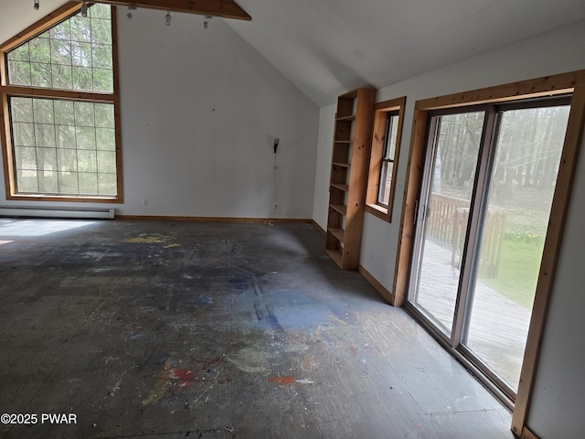 interior space with baseboards, a healthy amount of sunlight, vaulted ceiling, and baseboard heating
