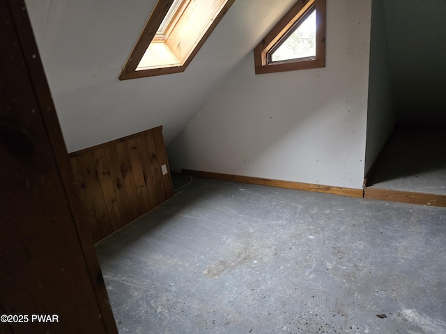 bonus room with vaulted ceiling with skylight