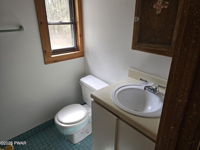 bathroom with vanity, tile patterned floors, and toilet