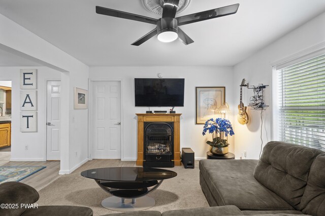 4 Pebble Ct, Lake Ariel, PA 18436 - living area with ceiling fan, a glass covered fireplace, light colored carpet, and baseboards