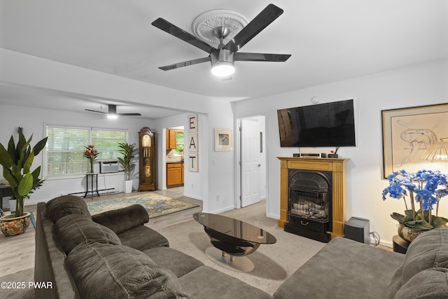 4 Pebble Ct, Lake Ariel, PA 18436 - living area featuring a ceiling fan, a glass covered fireplace, baseboards, baseboard heating, and light colored carpet