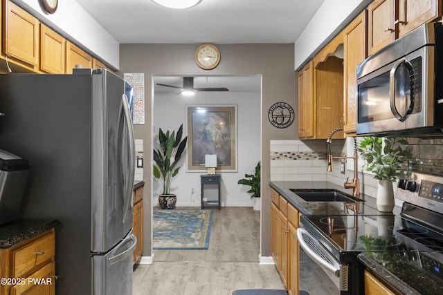 4 Pebble Ct, Lake Ariel, PA 18436 - kitchen with stainless steel appliances, a sink, light wood finished floors, and dark stone counters