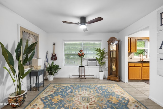 4 Pebble Ct, Lake Ariel, PA 18436 - living area featuring a baseboard radiator, ceiling fan, cooling unit, and light wood finished floors