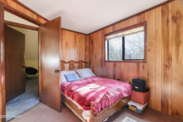 bedroom featuring wooden walls and carpet