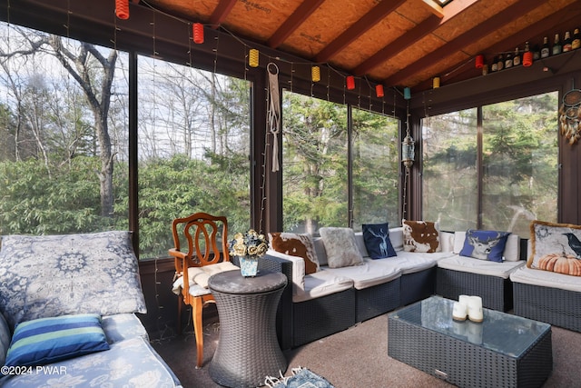 sunroom with vaulted ceiling with beams