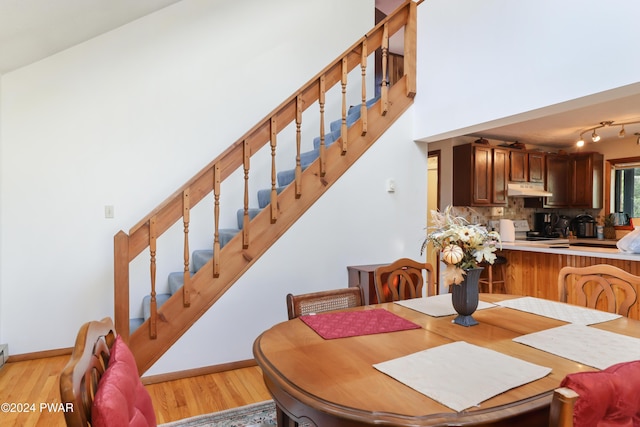 dining space featuring light hardwood / wood-style flooring and vaulted ceiling