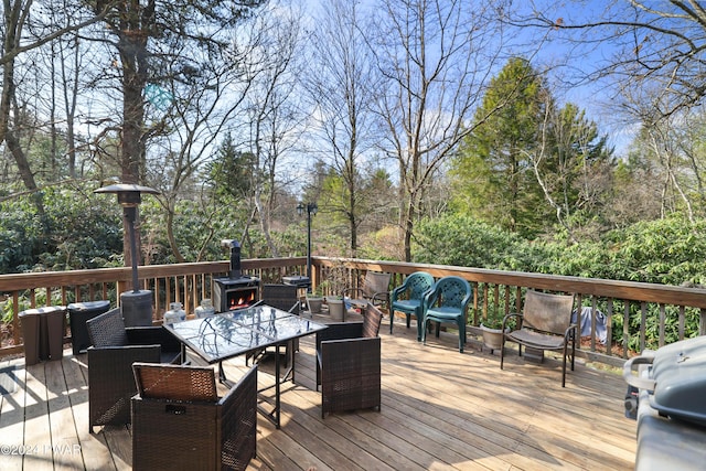 wooden terrace with a grill