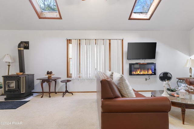 living room with carpet, a skylight, and a wood stove