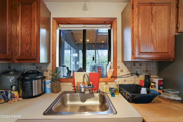 kitchen featuring decorative backsplash and sink