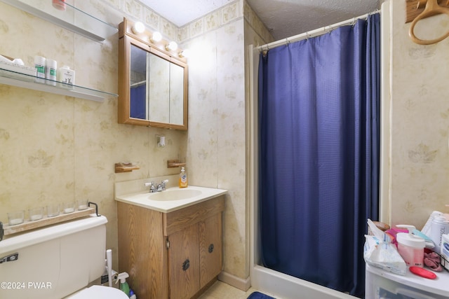 bathroom with a shower with shower curtain, vanity, toilet, and a textured ceiling