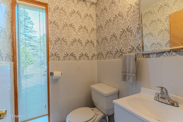 20 Clemen V Muller St, Beach Lake, PA 18405 - bathroom with wallpapered walls, vanity, tile walls, and a wainscoted wall